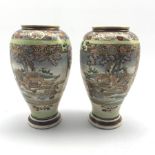 Pair of Japanese Satsuma vases decorated with scenes of warriors in landscapes, H28cm