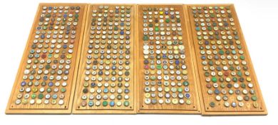 Large collection of Golf ball markers mounted on oak panels, 55cm x 23cm