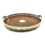 Early 20th Century oak oval tea tray with pierced plated two handled gallery and compressed bun fee