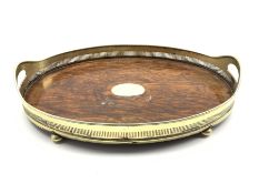 Early 20th Century oak oval tea tray with pierced plated two handled gallery and compressed bun fee