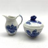 Royal Copenhagen cream jug and sucrier decorated with blue flowers within a basket weave moulded ri
