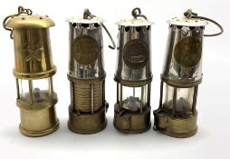Three Eccles Protector lamp & Lighting Co. Miners lamps including Type GR.6 and a decorative brass
