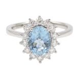 18ct white gold oval aquamarine and diamond cluster ring, hallmarked