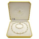 9ct yellow and white gold necklace and matching bracelet, both stamped 375, retailed by Hugh Rice in