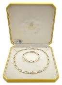 9ct yellow and white gold necklace and matching bracelet, both stamped 375, retailed by Hugh Rice in