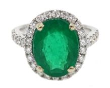 18ct white gold oval emerald and diamond ring, with diamond set shoulders, hallmarked, emerald appr