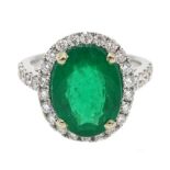 18ct white gold oval emerald and diamond ring, with diamond set shoulders, hallmarked, emerald appr