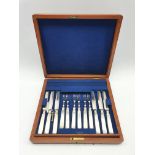 Set of twelve dessert knives and forks with plated blades, mother of pearl handles and silver collar