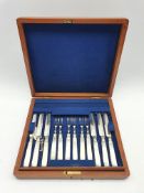 Set of twelve dessert knives and forks with plated blades, mother of pearl handles and silver collar