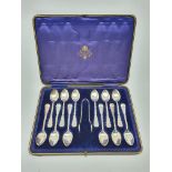 Set of twelve silver tea spoons and tongs, monogrammed and with decorative stems Sheffield 1905 Make