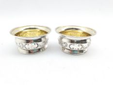 Pair of George III silver circular salts with gilded interiors and engraved with a band of trailing
