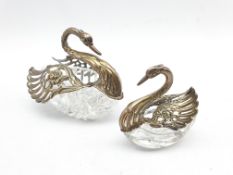 Pair of graduated glass Swan salts with pierced silver hinged wings and neck, import marks, larger s