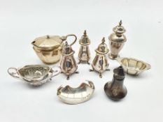 Pair of silver pepperettes Birmingham 1942, two others, silver mustard pot, two silver salts and oth