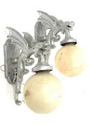 Pair of modern cast metal wall lights, each modelled as a winged dragon with globular shades, H68cm