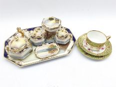 Noritake dressing table set decorated with a lake landscape within a blue and gilt border, seven pie