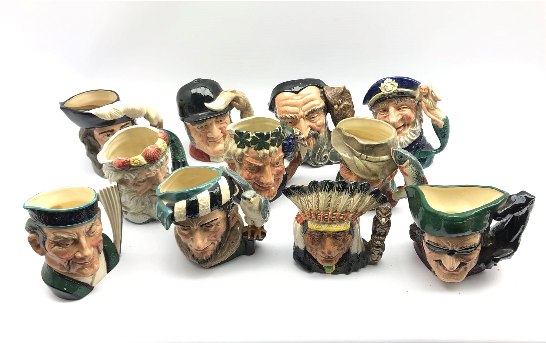 Eleven Royal Doulton character jugs comprising: North American Indian, Dick Turpin, Bacchus, The Poa