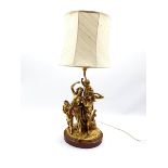 Gilded cast brass electric lamp base in the form of a Bacchanalian group of figures on red marble p