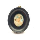 Miniature oval head and shoulders portrait of a fashionable lady in a large hat and in ebonised fram