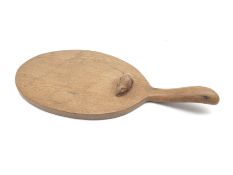 'Mouseman' oak cheeseboard of oval form with raised handle, by Robert Thompson of Kilburn, D56cm, H4