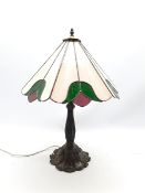 Tiffany style table lamp, leaded glass shade on lily pad moulded cast metal support, H69cm