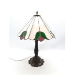 Tiffany style table lamp, leaded glass shade on lily pad moulded cast metal support, H69cm