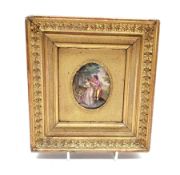 Miniature enamelled oval plaque of depicting a Family walking in a woodland, H7.5cm in a gilt frame