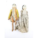Two peg dolls with carved limbs and painted rounded faces H27cm