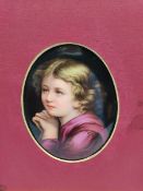 Continental oval porcelain plaque painted with a head and shoulders portrait of a child and inscribe