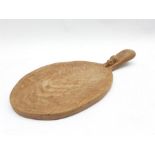 Thompson of Kilburn Mouseman oak cheese board of oval design, the raised handle with carved mouse si