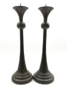 Pair of bronzed candlesticks, knopped stems on a tapered circular foot, H51cm