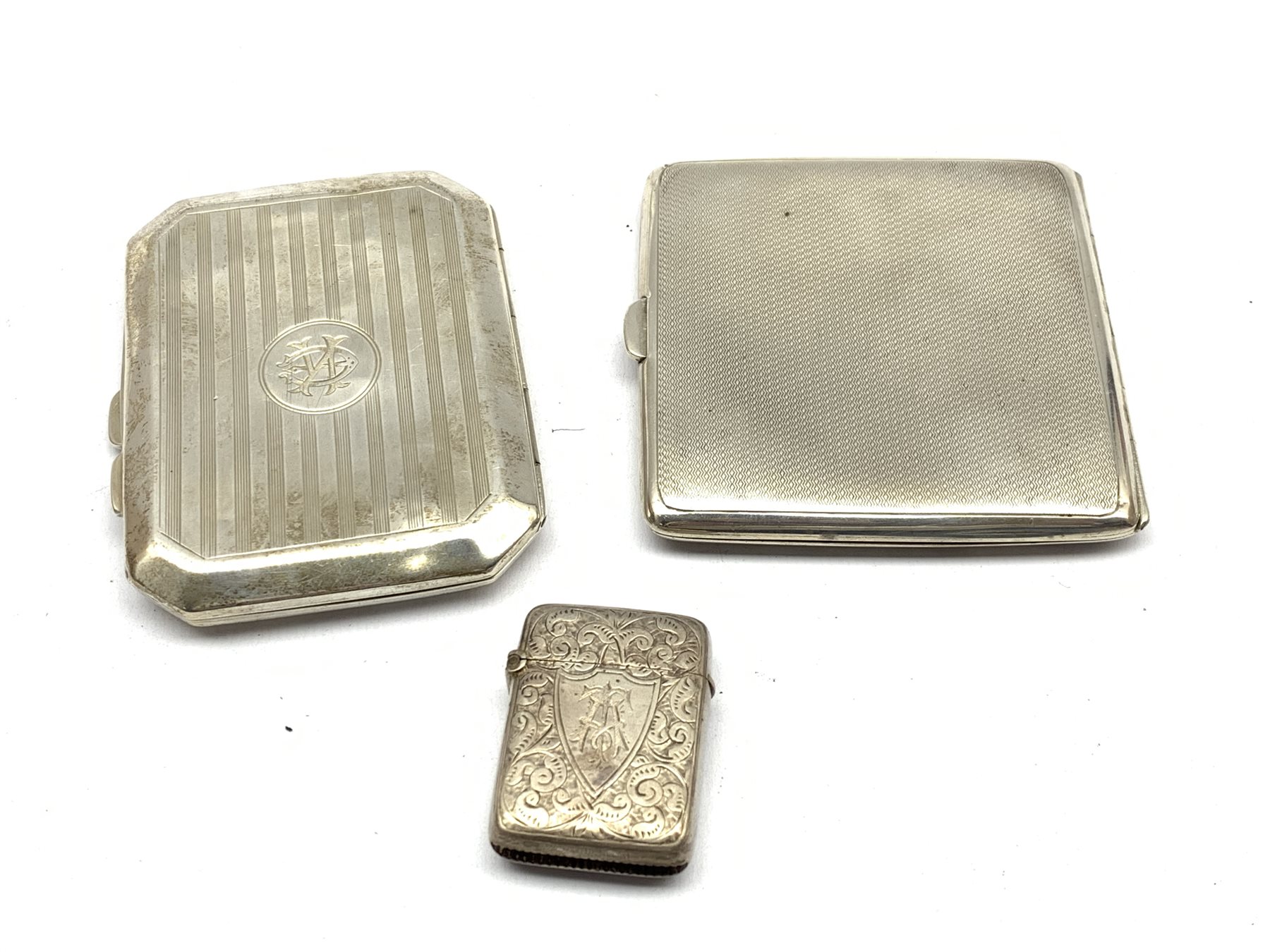 Engine turned silver cigarette case, Birmingham 1933, another engraved with a monogram, and a Victor