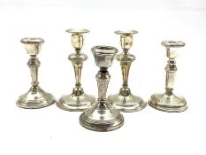 Pair of silver dressing table candlesticks Birmingham 1918 H13cm, a smaller pair H11cm and a similar