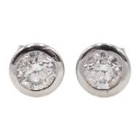 Pair of 18ct white gold bezel set diamond stud earrings, stamped 750, diamond total weight approx 1.