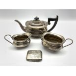Silver three piece tea set with egg and dart border, the tea pot with ebonised handle and lift Sheff