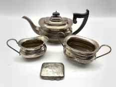 Silver three piece tea set with egg and dart border, the tea pot with ebonised handle and lift Sheff