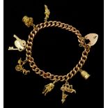 Gold curb link bracelet with heart locket and seven gold charms including horse and carriage, car an