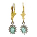 Pair of 9ct gold emerald and diamond cluster pendant earrings, boxed