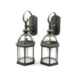 Pair of patinated metal porch lanterns of hexagonal form with bevelled glass panels, H57cm