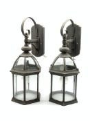 Pair of patinated metal porch lanterns of hexagonal form with bevelled glass panels, H57cm
