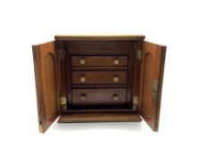 Victorian mahogany collectors cabinet, the hinged lid above two cupboard doors enclosing three gradu