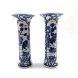 Pair of Chinese blue and white cylindrical vases, painted with Buffalo within moulded panels on a ce