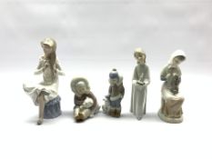 Two Lladro figures of Eskimo children with polar bear cubs, Nao figure of a girl brushing her hair a