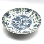 Chinese provincial charger decorated with flowers, foliage etc in blue and white D36cm