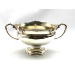 Silver two handled circular bowl with scroll moulded border and handles on a pedestal foot 12cm x 18