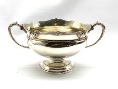 Silver two handled circular bowl with scroll moulded border and handles on a pedestal foot 12cm x 18