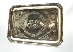 Edwardian silver rectangular dressing table tray embossed with angels heads and foliage 32cm x 23cm