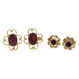 Pair of gold oval garnet stud earrings, open work design and one other similar pair, both 9ct stampe