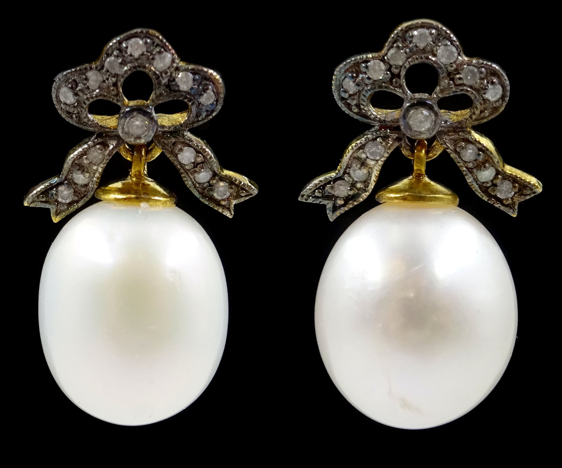 Pair of oval cultured pearl and diamond bow pendant earrings