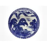 20th Century Japanese charger decorated with figures and lake landscape in blue and white D37cm