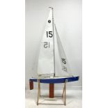 Remote controlled fibreglass pond yacht with nylet sails , weighted keel in blue and white livery wi